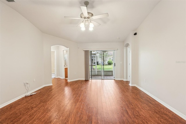 10150 Heather Sound Dr, Tampa, FL 33647 - empty room with arched walkways, wood finished floors, ceiling fan, and baseboards