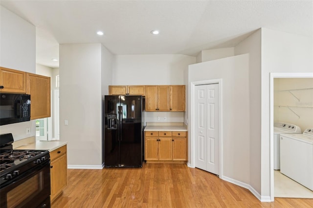 10150 Heather Sound Dr, Tampa, FL 33647 - kitchen featuring black appliances, washer and clothes dryer, light wood-style flooring, light countertops, and recessed lighting