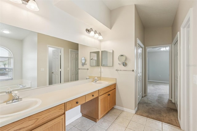 10150 Heather Sound Dr, Tampa, FL 33647 - full bathroom featuring tile patterned flooring, double vanity, a bath, and baseboards