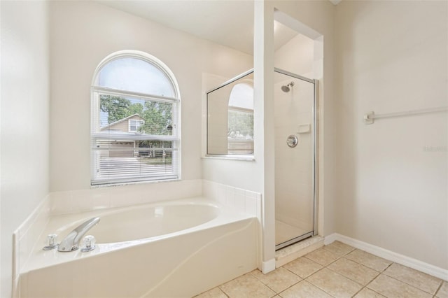 10150 Heather Sound Dr, Tampa, FL 33647 - full bathroom featuring tile patterned floors, a stall shower, and a garden tub