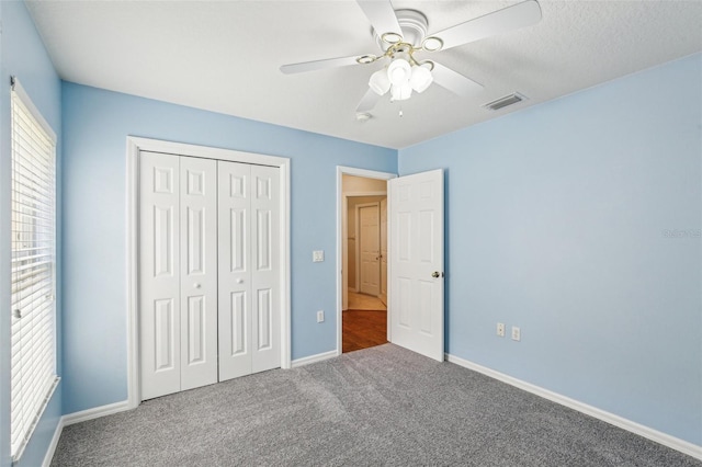 10150 Heather Sound Dr, Tampa, FL 33647 - unfurnished bedroom featuring carpet floors, a closet, baseboards, and a ceiling fan