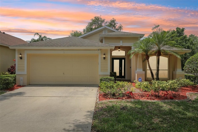 10150 Heather Sound Dr, Tampa, FL 33647 - view of front of home with a garage, concrete driveway, and roof with shingles