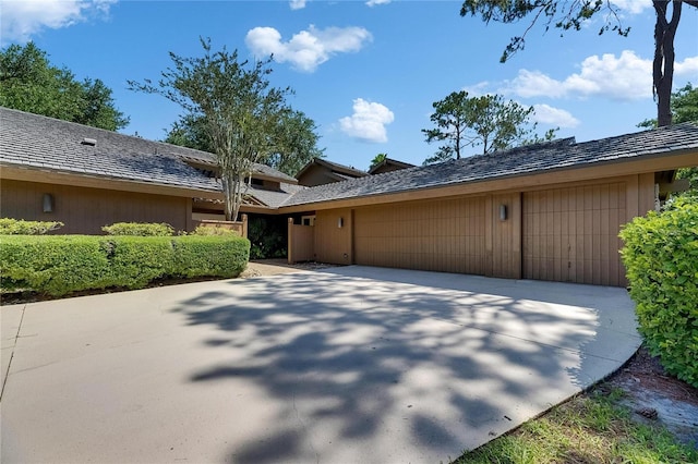 29903 Baywood Ln, Wesley Chapel, FL 33543 - view of property exterior featuring an attached garage and driveway