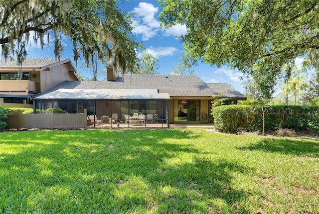 29903 Baywood Ln, Wesley Chapel, FL 33543 - back of house featuring a chimney, a sunroom, and a yard