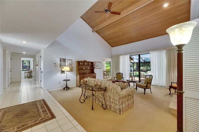 29903 Baywood Ln, Wesley Chapel, FL 33543 - living room featuring light carpet, light tile patterned floors, a ceiling fan, high vaulted ceiling, and baseboards