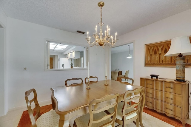 29903 Baywood Ln, Wesley Chapel, FL 33543 - dining room with a chandelier and a textured ceiling
