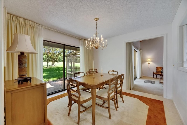 29903 Baywood Ln, Wesley Chapel, FL 33543 - dining room with a textured ceiling, a chandelier, and light carpet