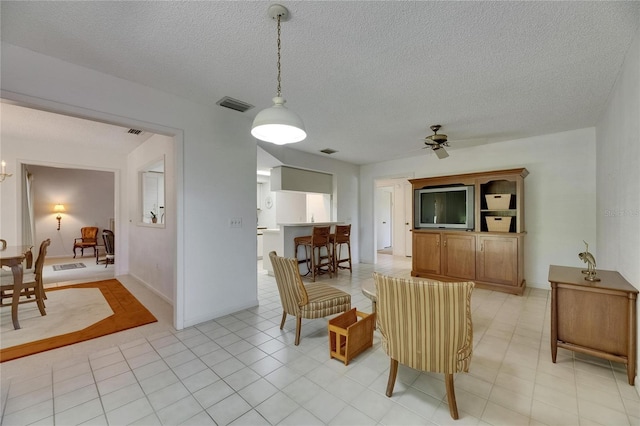 29903 Baywood Ln, Wesley Chapel, FL 33543 - dining room with ceiling fan and a textured ceiling