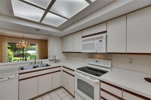 29903 Baywood Ln, Wesley Chapel, FL 33543 - kitchen featuring white appliances, a sink, and light countertops