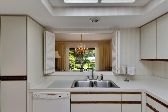 29903 Baywood Ln, Wesley Chapel, FL 33543 - kitchen with white dishwasher, a sink, light countertops, white cabinets, and a chandelier