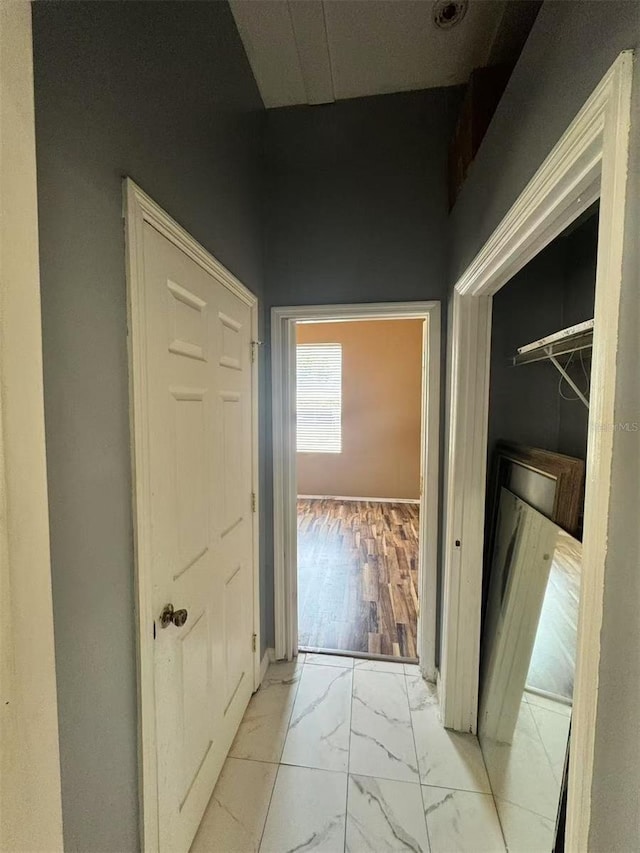 hallway with marble finish flooring