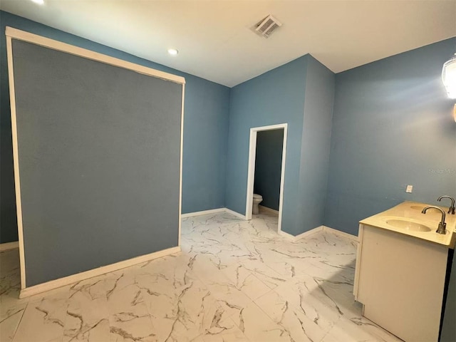 bathroom featuring marble finish floors, baseboards, toilet, recessed lighting, and vanity