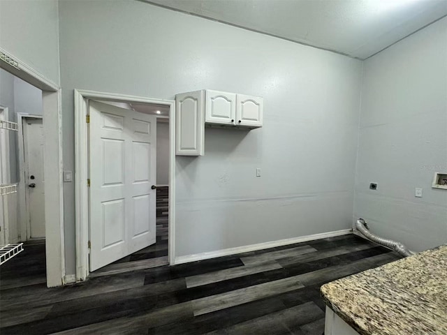 washroom with dark wood-style floors, hookup for an electric dryer, and baseboards