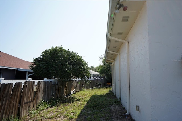 view of property exterior featuring fence and stucco siding
