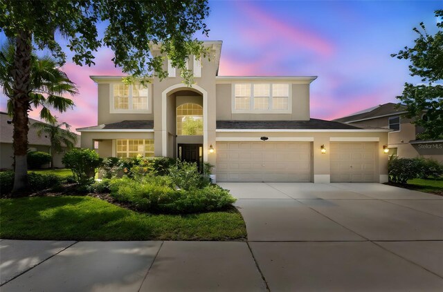 10837 Breaking Rocks Dr, Tampa, FL 33647 - view of front of house featuring stucco siding, concrete driveway, and an attached garage
