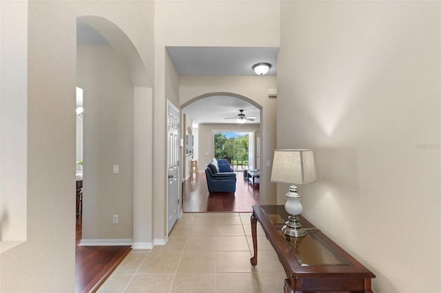 10837 Breaking Rocks Dr, Tampa, FL 33647 - hallway with arched walkways and light tile patterned flooring