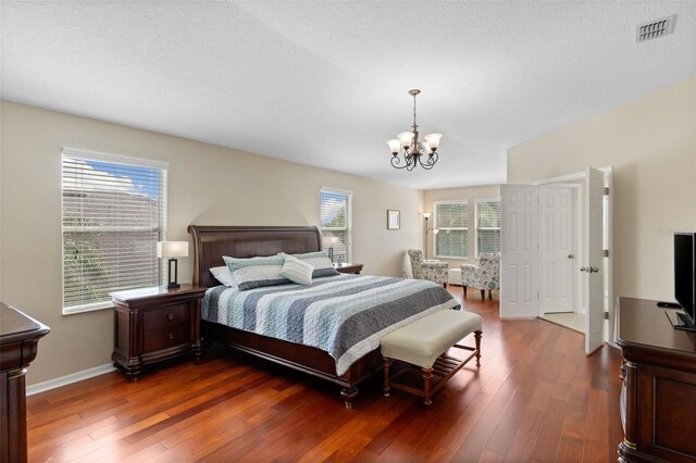 10837 Breaking Rocks Dr, Tampa, FL 33647 - bedroom with a chandelier, wood finished floors, multiple windows, and baseboards