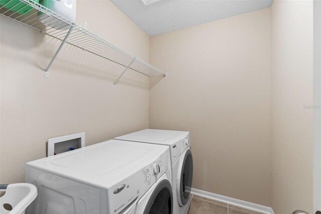 10837 Breaking Rocks Dr, Tampa, FL 33647 - washroom with washing machine and dryer, baseboards, and tile patterned floors