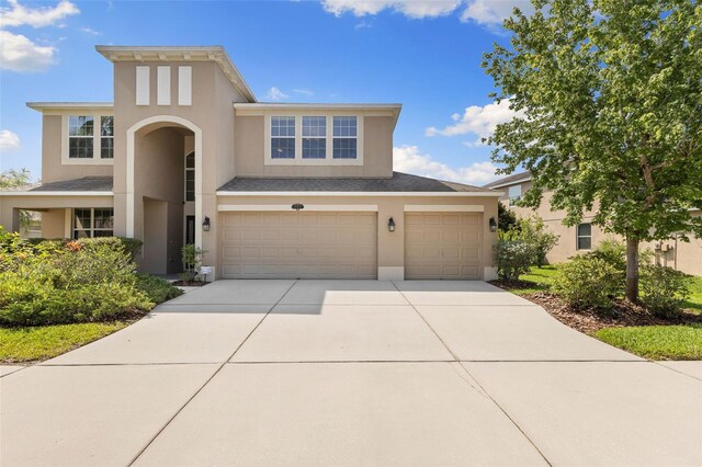 10837 Breaking Rocks Dr, Tampa, FL 33647 - view of front facade featuring stucco siding, concrete driveway, and an attached garage