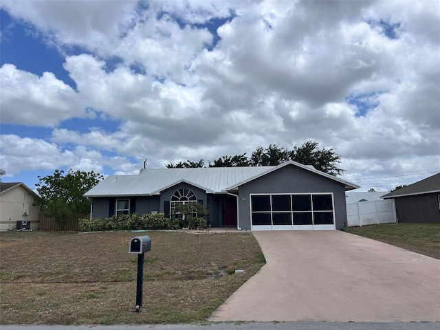 single story home with driveway, metal roof, a garage, and stucco siding