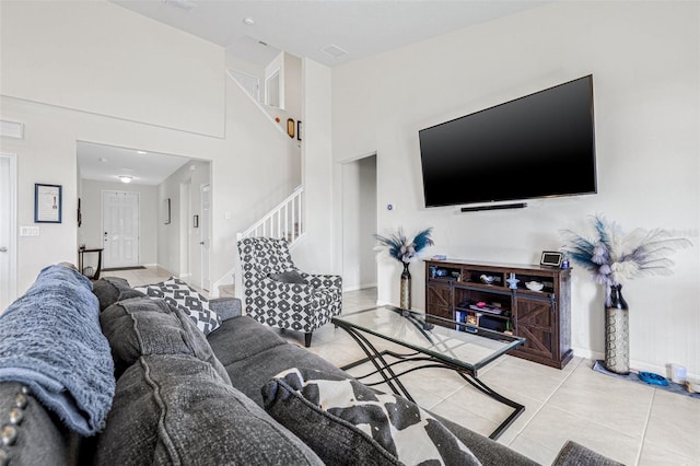11917 Greenchop Pl, Riverview, FL 33579 - living room featuring light tile patterned floors, stairs, baseboards, and a high ceiling