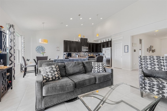 11917 Greenchop Pl, Riverview, FL 33579 - living area featuring light tile patterned floors, recessed lighting, baseboards, and high vaulted ceiling