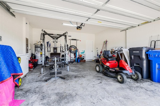 11917 Greenchop Pl, Riverview, FL 33579 - garage with water heater, a garage door opener, electric panel, and concrete block wall