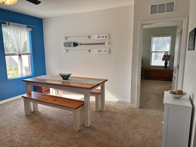 2987 Neverland Dr, New Smyrna Beach, FL 32168 - dining space with carpet floors, a ceiling fan, and baseboards