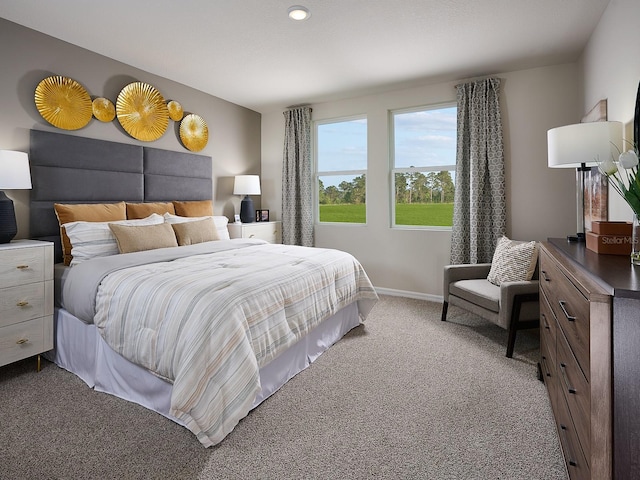 carpeted bedroom featuring baseboards and recessed lighting