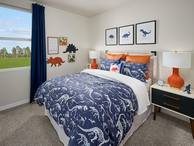 carpeted bedroom featuring baseboards