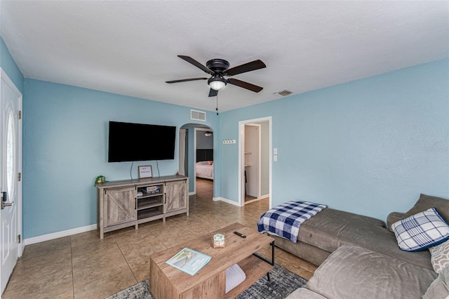 2035 29th Ave N, Saint Petersburg, FL 33713 - tiled living area featuring arched walkways, ceiling fan, and baseboards