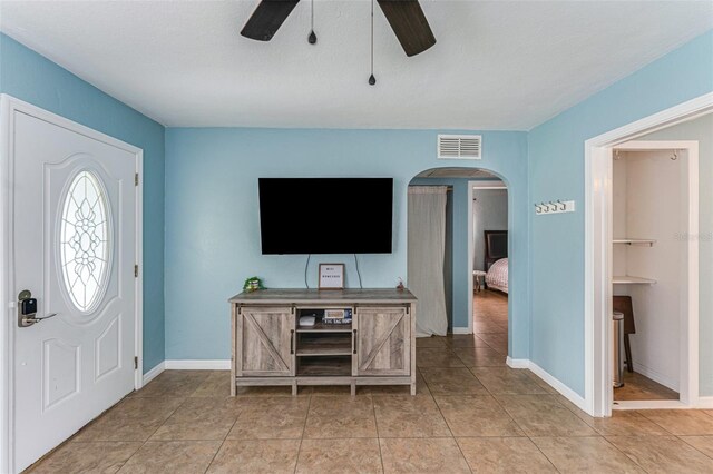 2035 29th Ave N, Saint Petersburg, FL 33713 - foyer entrance with ceiling fan, arched walkways, baseboards, and light tile patterned floors