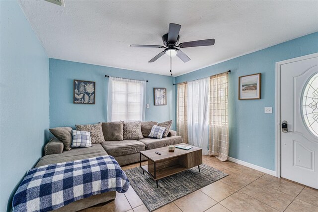 2035 29th Ave N, Saint Petersburg, FL 33713 - living room featuring light tile patterned floors, a ceiling fan, a textured ceiling, and baseboards
