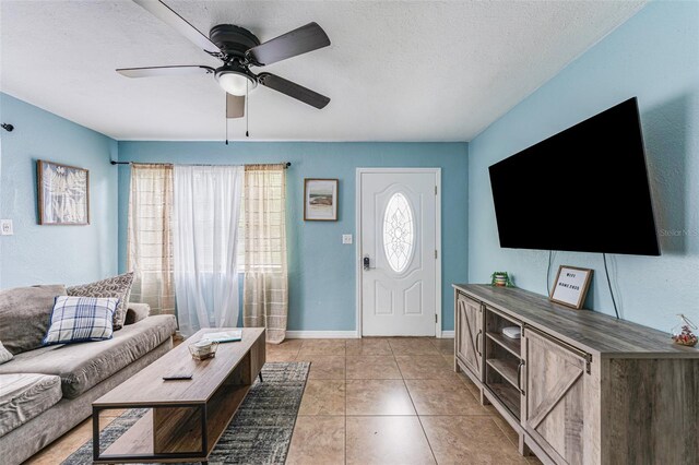 2035 29th Ave N, Saint Petersburg, FL 33713 - living room with ceiling fan, a textured ceiling, light tile patterned flooring, and baseboards