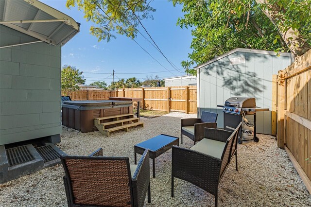 2035 29th Ave N, Saint Petersburg, FL 33713 - view of patio / terrace featuring a hot tub, a grill, a fenced backyard, a shed, and an outdoor living space