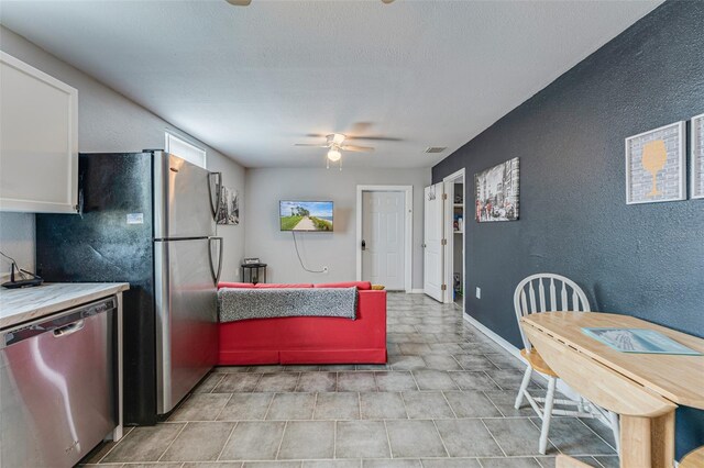 2035 29th Ave N, Saint Petersburg, FL 33713 - kitchen with appliances with stainless steel finishes, a ceiling fan, a textured wall, light countertops, and a textured ceiling