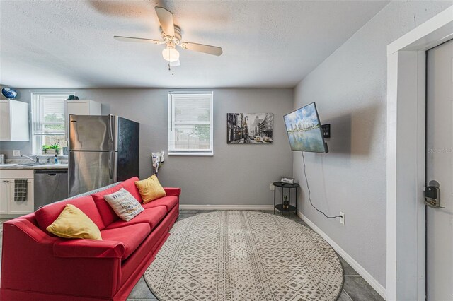 2035 29th Ave N, Saint Petersburg, FL 33713 - living room with a textured ceiling, ceiling fan, and baseboards