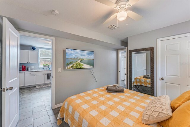 2035 29th Ave N, Saint Petersburg, FL 33713 - bedroom with light tile patterned flooring, a sink, baseboards, and a ceiling fan