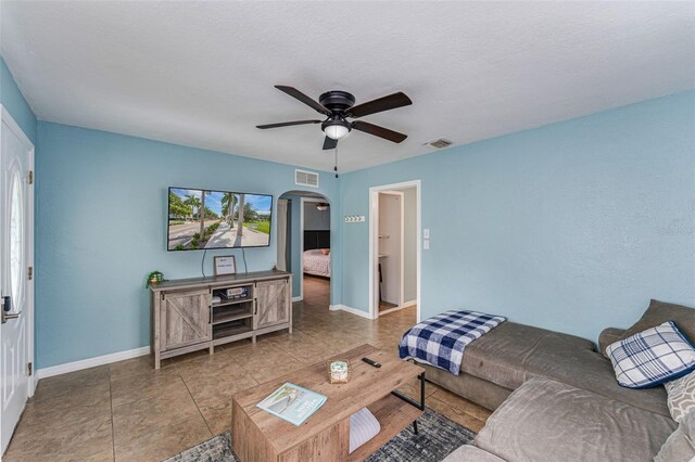2035 29th Ave N, Saint Petersburg, FL 33713 - tiled living room featuring arched walkways, ceiling fan, and baseboards