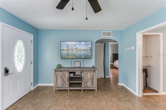 2035 29th Ave N, Saint Petersburg, FL 33713 - foyer with ceiling fan, arched walkways, baseboards, and light tile patterned floors
