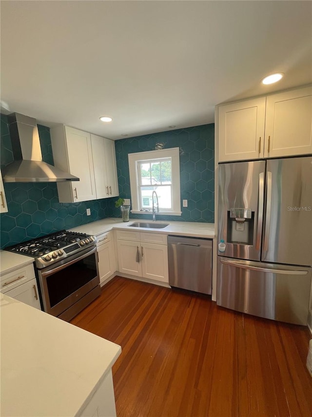 145 20th Ave SE, Saint Petersburg, FL 33705 - kitchen with wall chimney exhaust hood, appliances with stainless steel finishes, a sink, white cabinetry, and light countertops
