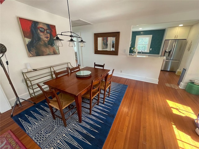 145 20th Ave SE, Saint Petersburg, FL 33705 - dining room featuring wood finished floors and baseboards