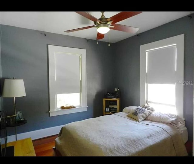 145 20th Ave SE, Saint Petersburg, FL 33705 - bedroom featuring wood finished floors, baseboards, and a ceiling fan