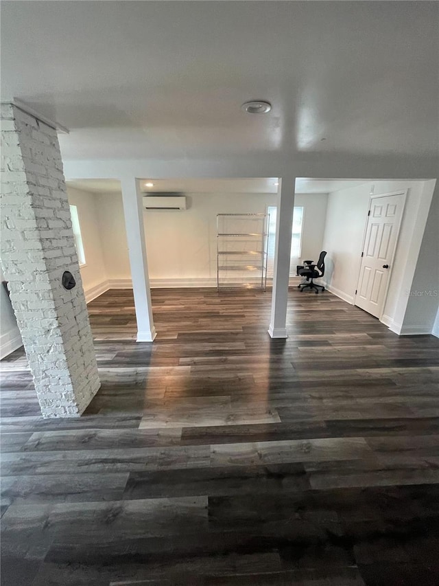145 20th Ave SE, Saint Petersburg, FL 33705 - basement with a wall unit AC, baseboards, and dark wood-style floors