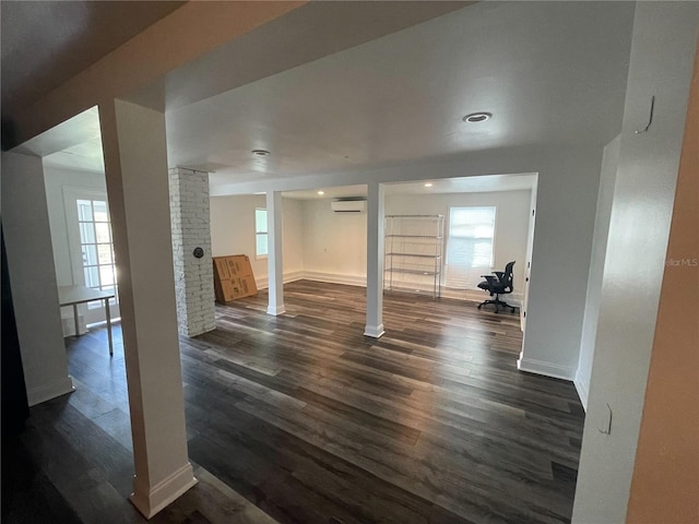 145 20th Ave SE, Saint Petersburg, FL 33705 - below grade area with dark wood finished floors, a wall mounted AC, baseboards, and recessed lighting