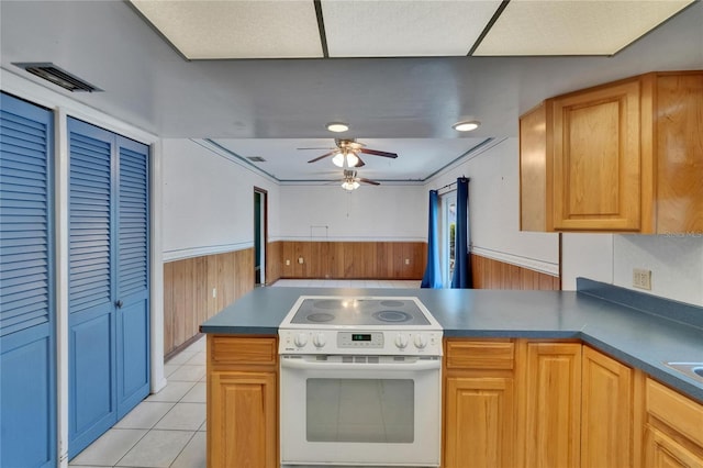 508 E Brentridge, Brandon, FL 33511 - kitchen featuring white electric range, wainscoting, a peninsula, a ceiling fan, and wood walls