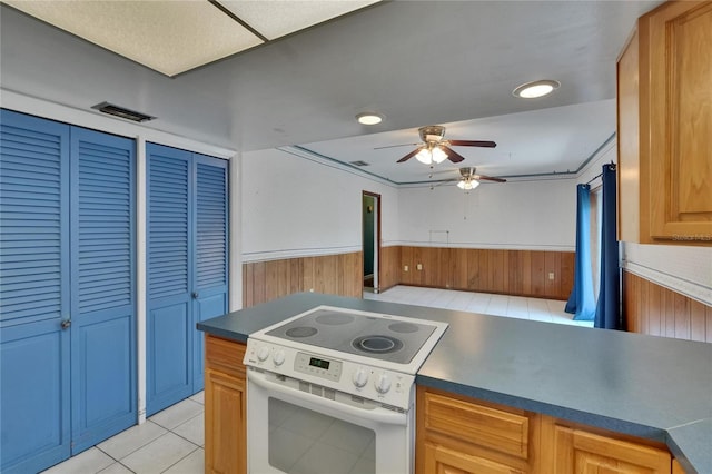 508 E Brentridge, Brandon, FL 33511 - kitchen featuring electric stove, ceiling fan, wainscoting, wooden walls, and light tile patterned floors