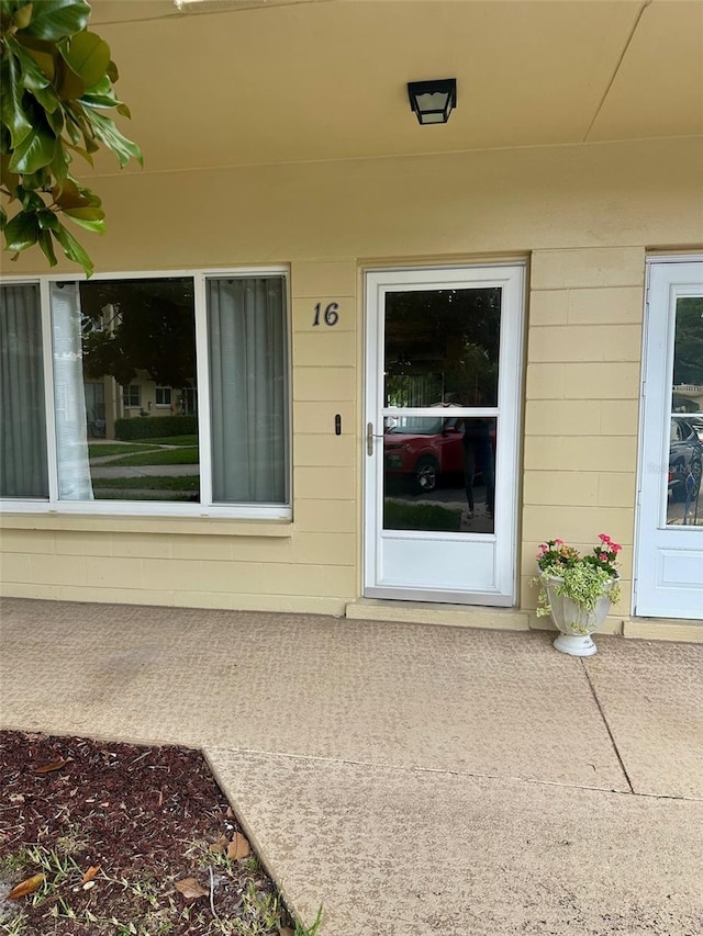 2360 Irish Ln Unit 16, Clearwater, FL 33763 - view of exterior entry featuring concrete block siding