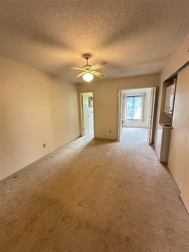 2360 Irish Ln Unit 16, Clearwater, FL 33763 - spare room with washer / clothes dryer, light colored carpet, a textured ceiling, and a ceiling fan