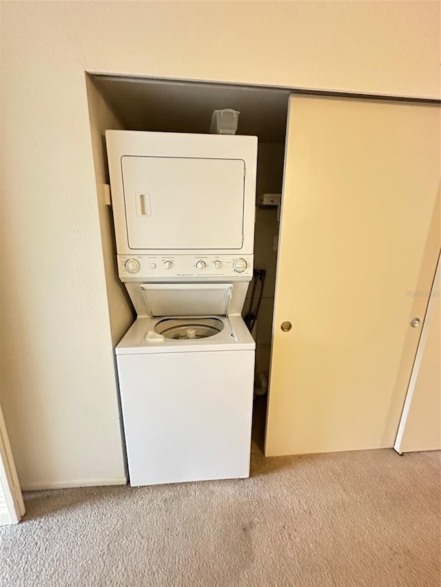 2360 Irish Ln Unit 16, Clearwater, FL 33763 - laundry area featuring stacked washer and clothes dryer and light colored carpet